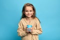 Little child girl holding milkshake in disposable paper cup Royalty Free Stock Photo