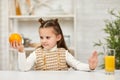 Little child girl holding oranges and juice Royalty Free Stock Photo
