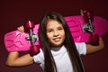 little child girl holding pink skateboard