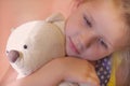 Little Child Girl Hugging Her Toy Bear At Home. soft focus on toy Royalty Free Stock Photo