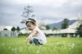 Little child girl playing with bubbles on green grass outdoors in the park Royalty Free Stock Photo