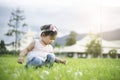 Little child girl playing with bubbles on green grass outdoors in the park Royalty Free Stock Photo