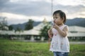 Little child girl playing with bubbles on green grass outdoors in the park Royalty Free Stock Photo