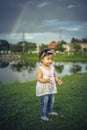 Little child girl playing with bubbles on green grass outdoors in the park Royalty Free Stock Photo