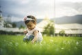 Little child girl playing with bubbles on green grass outdoors in the park Royalty Free Stock Photo