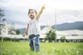 Little child girl playing with bubbles on green grass outdoors in the park Royalty Free Stock Photo