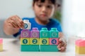 Little child girl playing colorful blocks