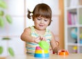 Little child girl playing with educational toys