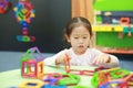 Little child girl playing Magnets toy for brain development Royalty Free Stock Photo