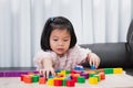 Little child girl playing wood block on the table. Happy kid building construction with toys block. Royalty Free Stock Photo