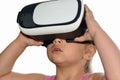 Little child girl plays a game with virtual reality glasses on white background, augmented reality, helmet, computer game, enterta Royalty Free Stock Photo