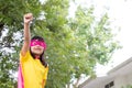 Little child girl plays superhero. Child on the white background. Girl power concept Royalty Free Stock Photo