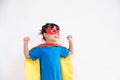 Little child girl plays superhero. Child on the white background. Girl power concept Royalty Free Stock Photo