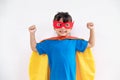 Little child girl plays superhero. Child on the white background. Girl power concept Royalty Free Stock Photo