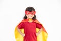 Little child girl plays superhero. Child on the white background. Girl power concept Royalty Free Stock Photo