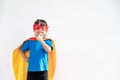 Little child girl plays superhero. Child on the white background. Girl power concept Royalty Free Stock Photo