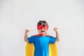 Little child girl plays superhero. Child on the white background. Girl power concept Royalty Free Stock Photo