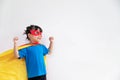 Little child girl plays superhero. Child on the white background. Girl power concept Royalty Free Stock Photo