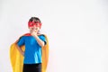 Little child girl plays superhero. Child on the white background. Girl power concept Royalty Free Stock Photo