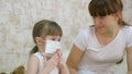 Little child girl quarantine, puts a medical mask on a toy bear. protection against caronovirus and influenza. baby