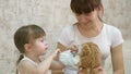 Little child girl quarantine, puts a medical mask on toy bear. protection against coronavirus and influenza. baby plays