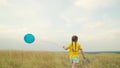 little child girl runs along rural road with blue balloon hands. happy childhood dream. rest kid outdoors park. picnic Royalty Free Stock Photo