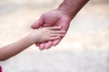 Little child girl shaking left hands with asian old  man right hand  on background Royalty Free Stock Photo