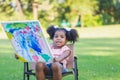 Little child girl shows her painting work. Cute kid show painting work in the garden Royalty Free Stock Photo