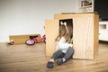 Child sitting in a cardboard playhouse Royalty Free Stock Photo