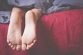 Little child girl sleeping in bed. Feet under the blanket as symbol of sleep and relax. Free copy space for design Royalty Free Stock Photo