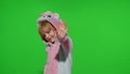 Little child girl smiling, waving greeting, hello or bye with hand in unicorn pajamas on chroma key