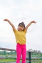 Little child girl Superhero in a gesture to fly on white background. Kid super hero concept Royalty Free Stock Photo