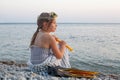 Little child girl in swimsuit, mask, snorkel and flippers sitting by the sea beach Royalty Free Stock Photo