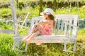 Little child girl is swinging on a swing in summer park. Sunny joyful summer day. Little girl having fun on a swing Royalty Free Stock Photo