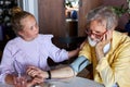 Little child girl take care of sick granddad, measure blood pressure using a tonometer Royalty Free Stock Photo