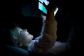 Little child girl using tablet technology in bed by night at home. Happy kid daughter in bedroom watching movie or Royalty Free Stock Photo