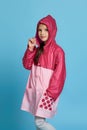 Little child girl is wearing waterproof raincoat