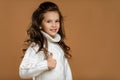 Little child girl in white sweater showing thumbs up Royalty Free Stock Photo