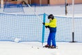 Little child going up the ski slope on ski lift. Royalty Free Stock Photo