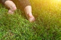 Little child on the grass, baby feet on the green grass in the park Royalty Free Stock Photo