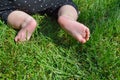 Little child on the grass, baby feet on the green grass in the park Royalty Free Stock Photo