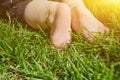 Little child on the grass, baby feet on the green grass in the park Royalty Free Stock Photo