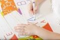 Little child hands writing letter A