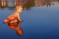 Little child has a fun on black sand sunset sea beach Royalty Free Stock Photo