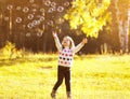 Little child having fun with bubbles soap in sunny autumn day Royalty Free Stock Photo