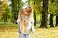 little child is having fun with her mother in city park, happy family life, kid girl on her back mom laughs, childish Royalty Free Stock Photo