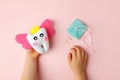 Little child holding felt tooth fairy toy in his hands on pink background. Easy and funny kids crafts, DIY, Happy Tooth Fairy Royalty Free Stock Photo