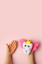 Little child holding felt tooth fairy toy in his hands on pink background. Easy and funny kids crafts, DIY, Happy Tooth Fairy Royalty Free Stock Photo