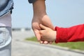 Little child holding hands with his father outdoors. Royalty Free Stock Photo