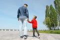 Little child holding hands with his father. Family weekend Royalty Free Stock Photo